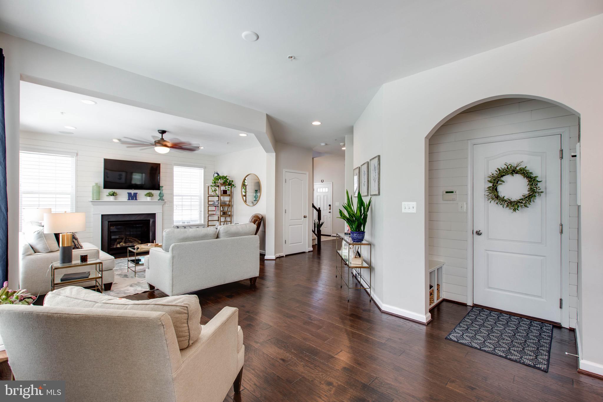 7870 Sunhaven Way Severn, MD 21144 - Photo 17 of 70 a living room with furniture a fireplace and a potted plant