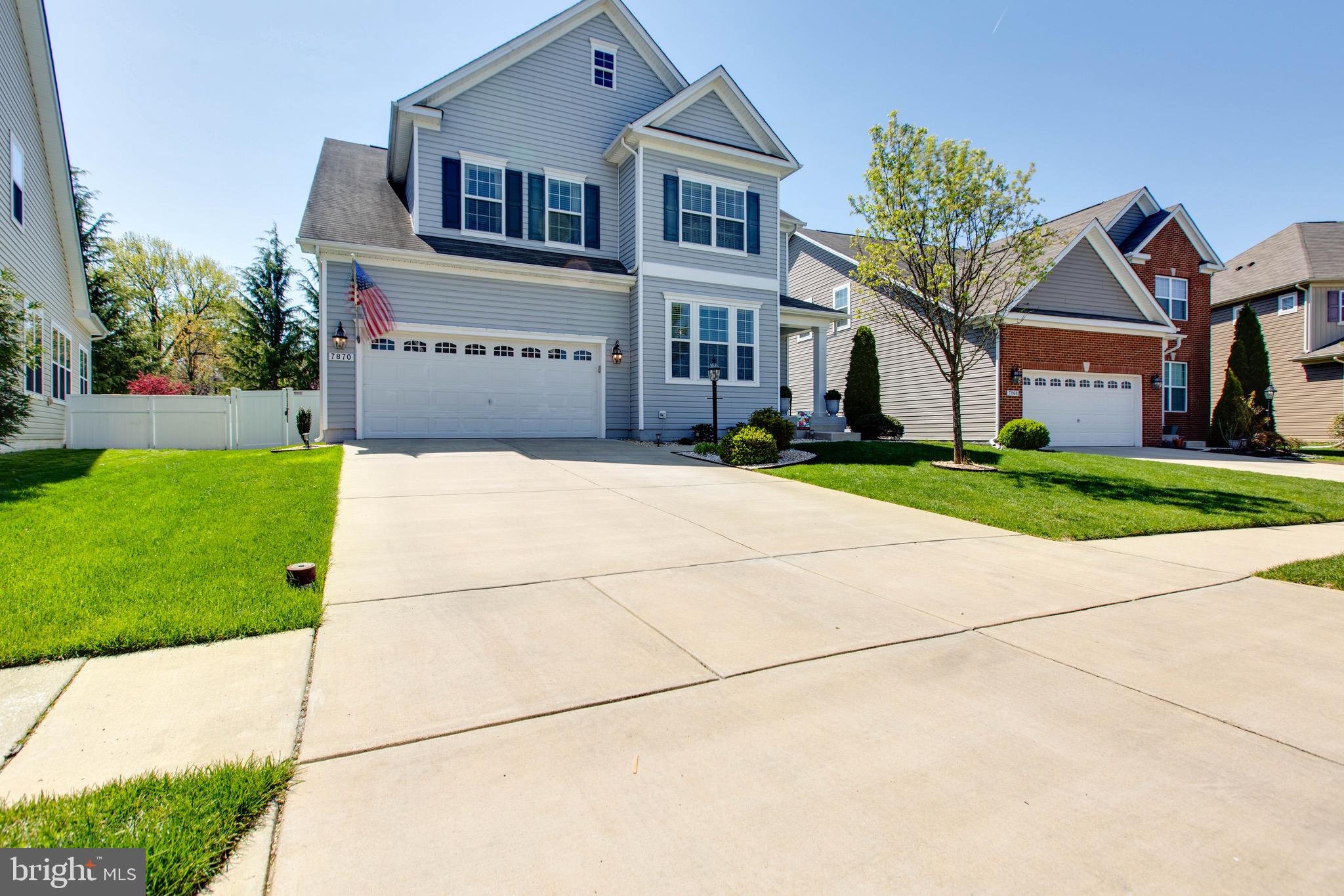7870 Sunhaven Way Severn, MD 21144 - Photo 4 of 70 a front view of a house with a yard and trees