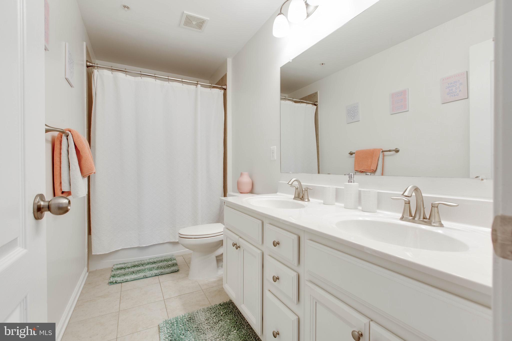 7870 Sunhaven Way Severn, MD 21144 - Photo 43 of 70 a bathroom with a double vanity sink toilet and shower