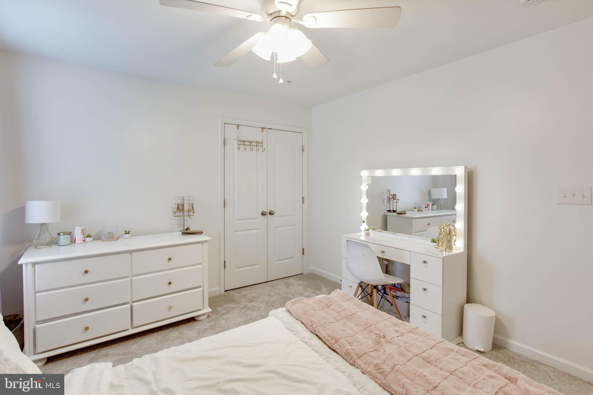 7870 Sunhaven Way Severn, MD 21144 - Photo 45 of 70 a bedroom with a bed and a chandelier