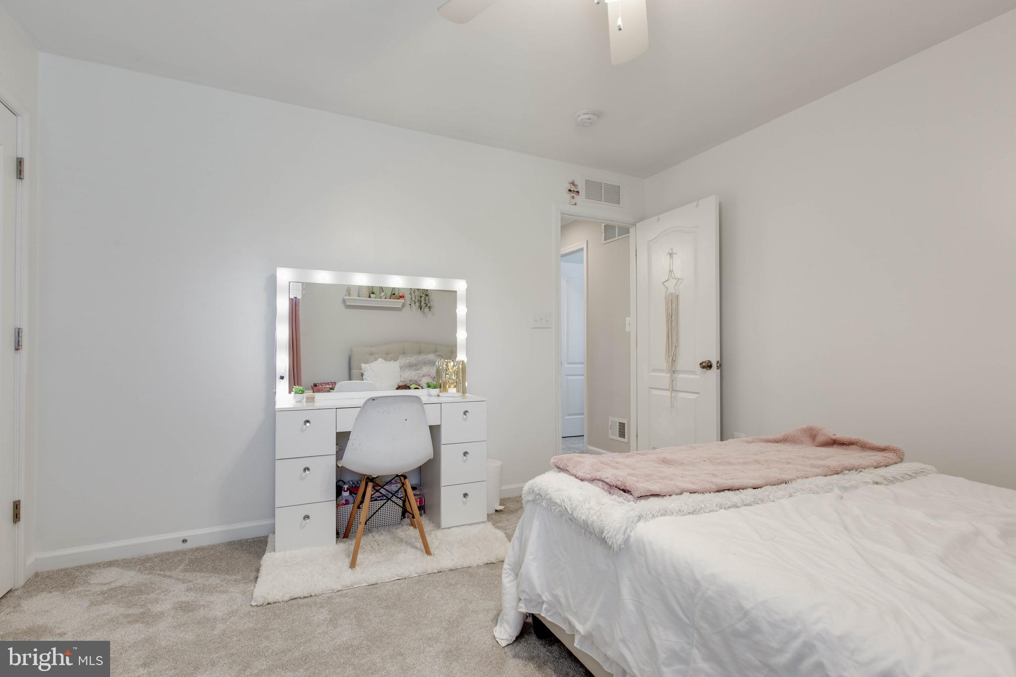 7870 Sunhaven Way Severn, MD 21144 - Photo 47 of 70 a bedroom with a bed and a table chair