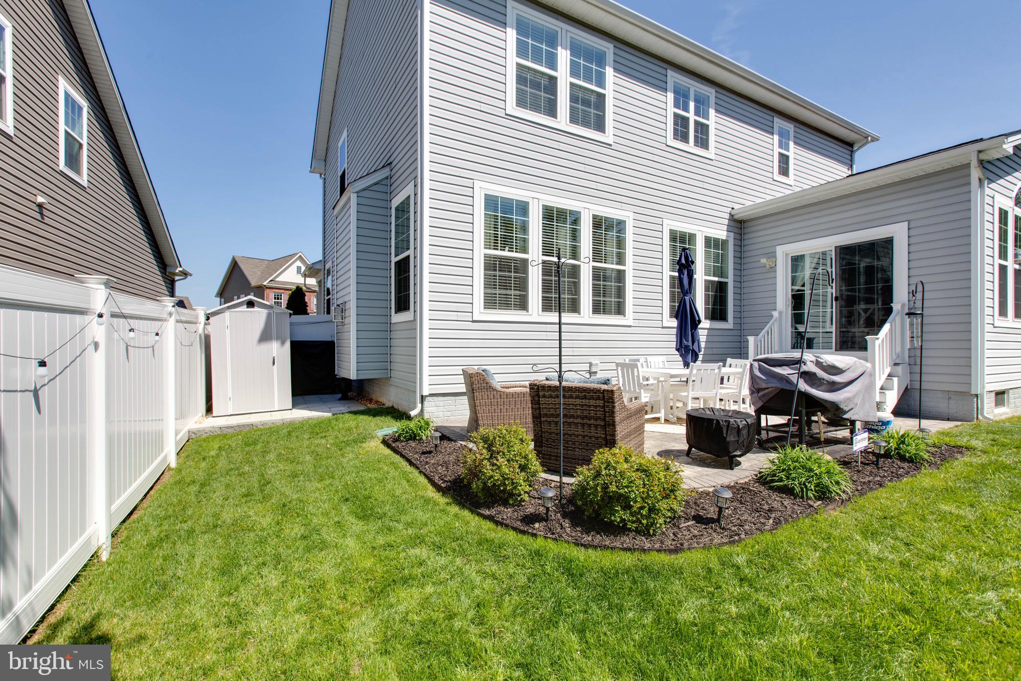 7870 Sunhaven Way Severn, MD 21144 - Photo 60 of 70 a front view of a house with porch and garden