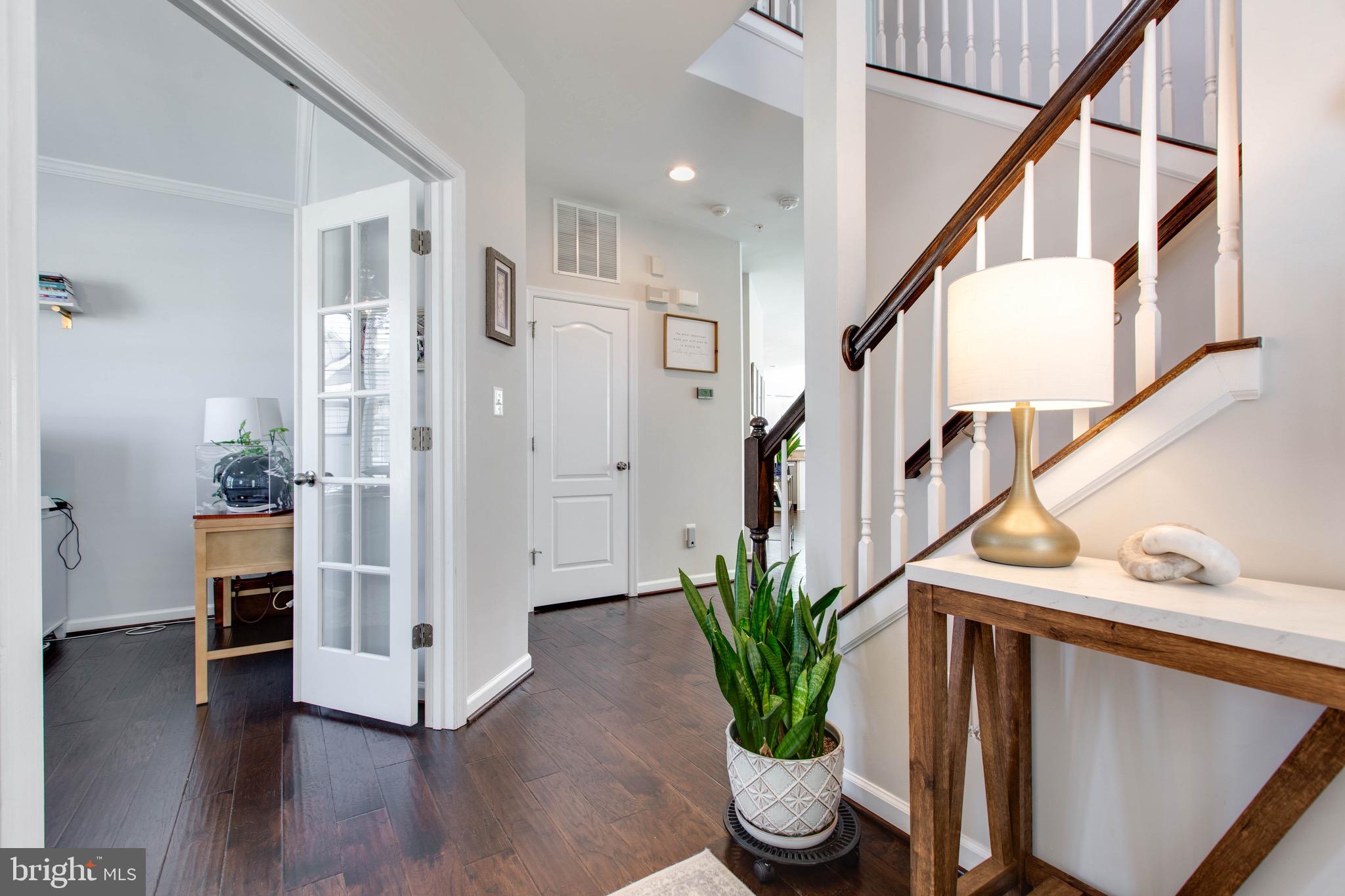 7870 Sunhaven Way Severn, MD 21144 - Photo 7 of 70 a view of an entryway with wooden floor and a potted plant