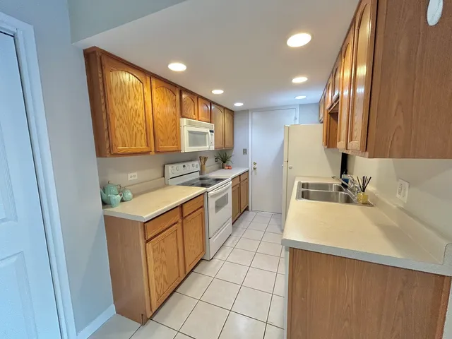 a kitchen with a sink a stove top oven and cabinets