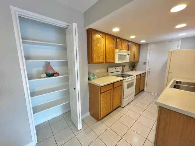 a kitchen with a stove a sink and a refrigerator