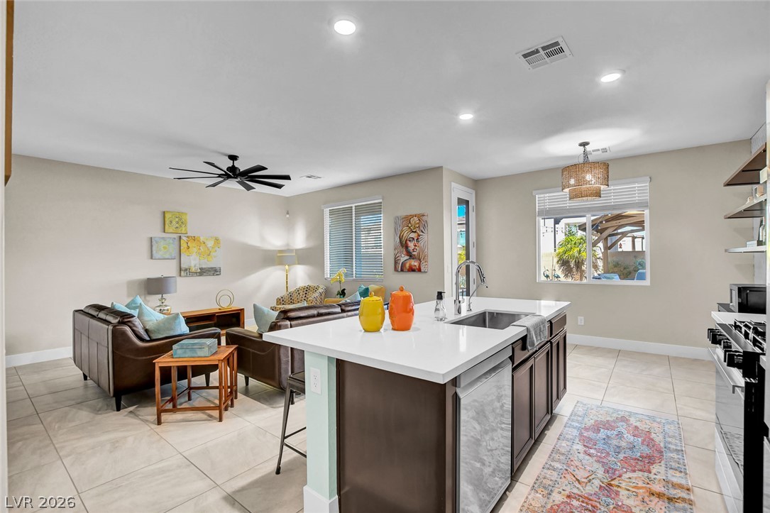 9688 Rankin Rdg Court Las Vegas, NV 89178 - Photo 53 of 53 An open floor plan seamlessly connects the well-appointed kitchen to a bright living area, perfect for entertaining.