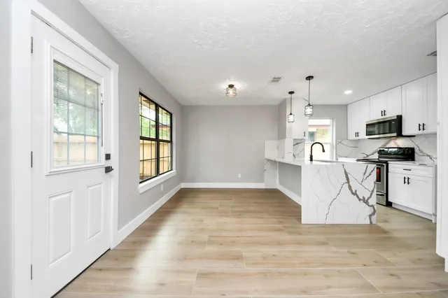 a view of a kitchen with a sink and cabinets