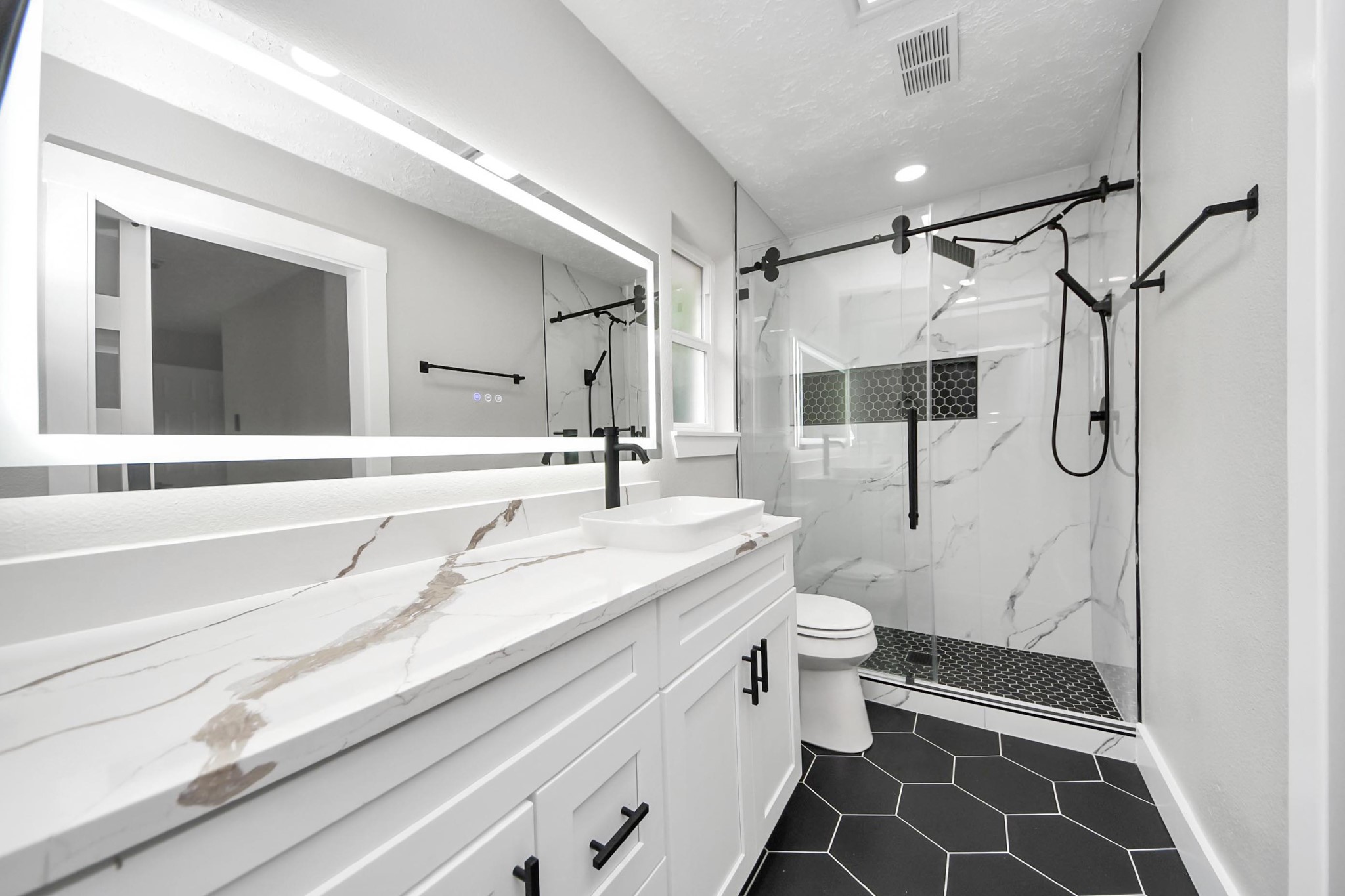 20010 Cottonglade Lane Humble, TX 77338 - Photo 13 of 27 a bathroom with a sink a toilet and shower