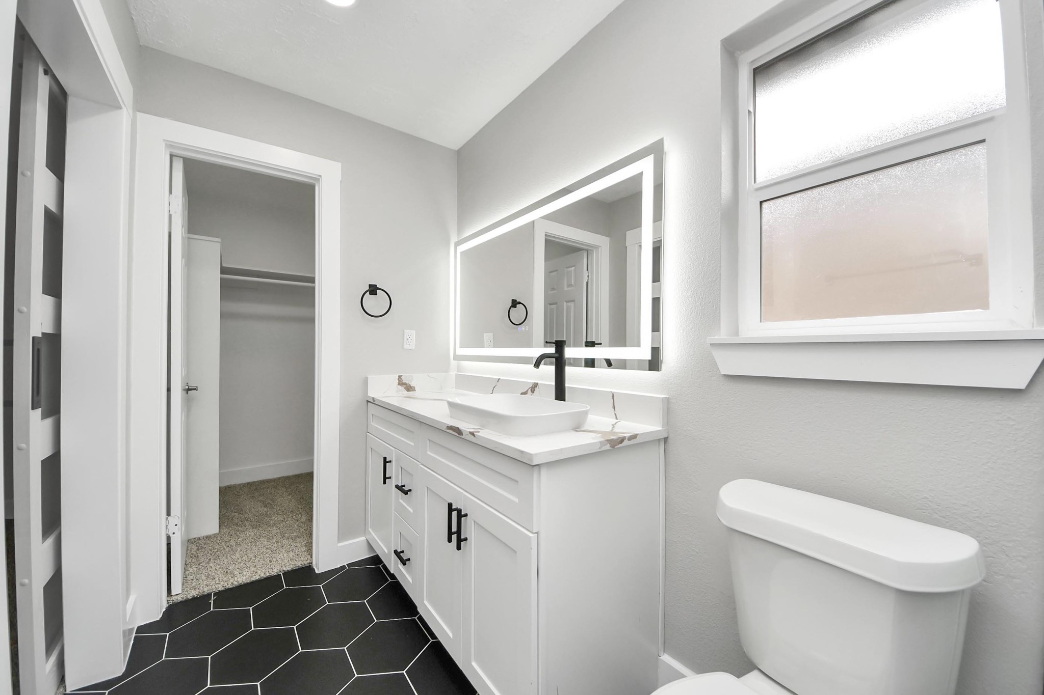20010 Cottonglade Lane Humble, TX 77338 - Photo 14 of 27 a bathroom with a granite countertop sink a toilet and a mirror