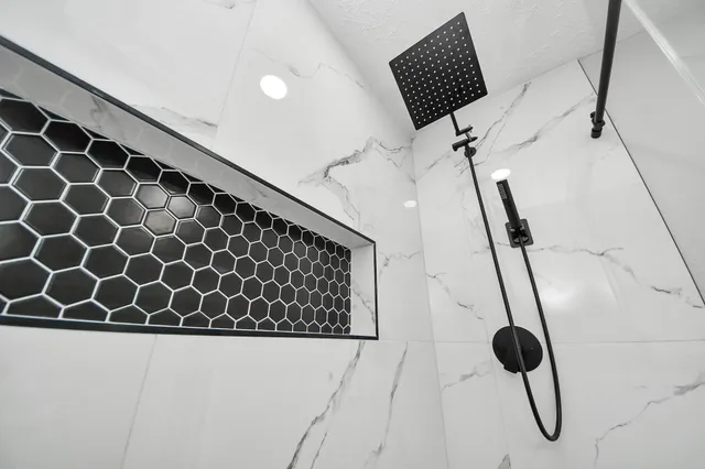 a bathroom with a granite countertop sink a toilet and a mirror