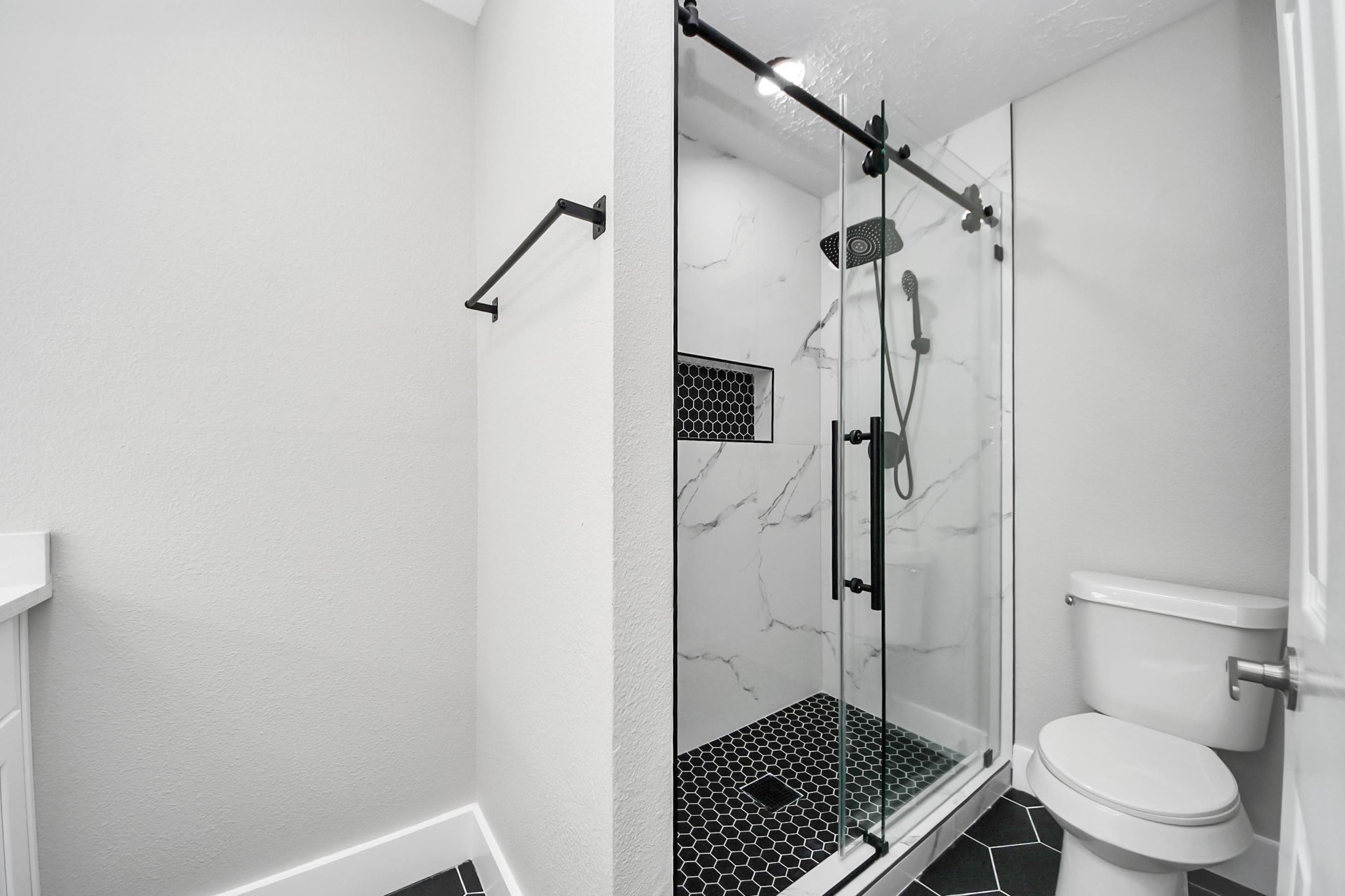 20010 Cottonglade Lane Humble, TX 77338 - Photo 19 of 27 a bathroom with a shower toilet and sink