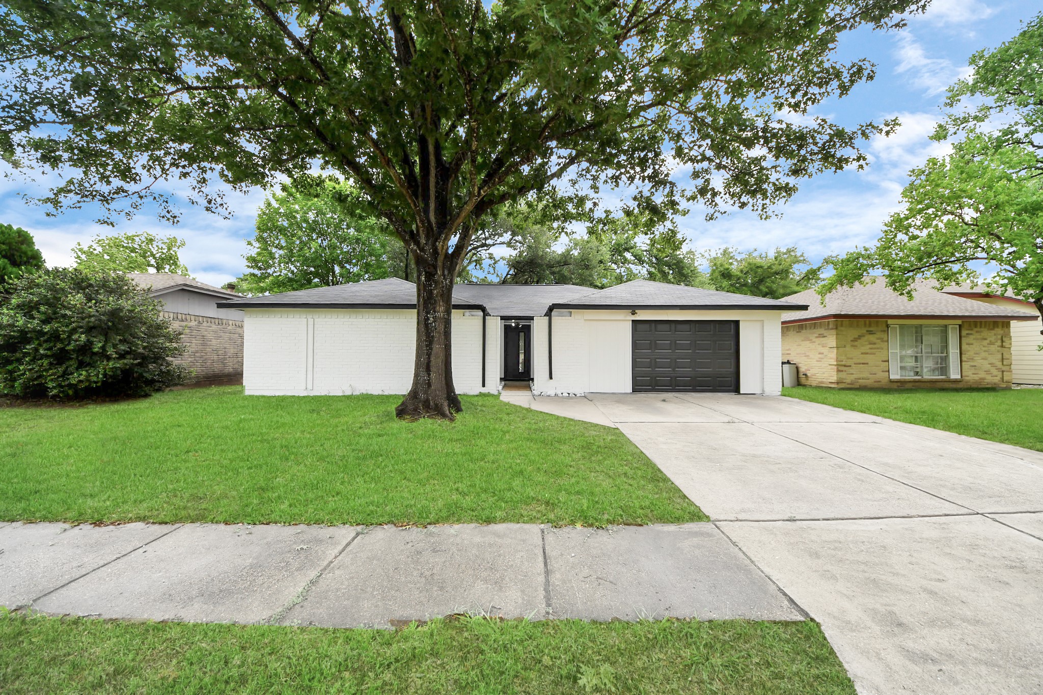 20010 Cottonglade Lane Humble, TX 77338 - Photo 2 of 27 front view of a house with a yard