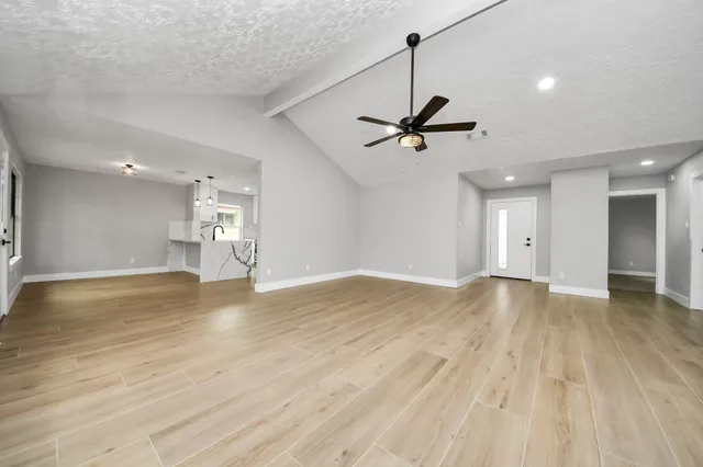 a view of backyard with deck and green space