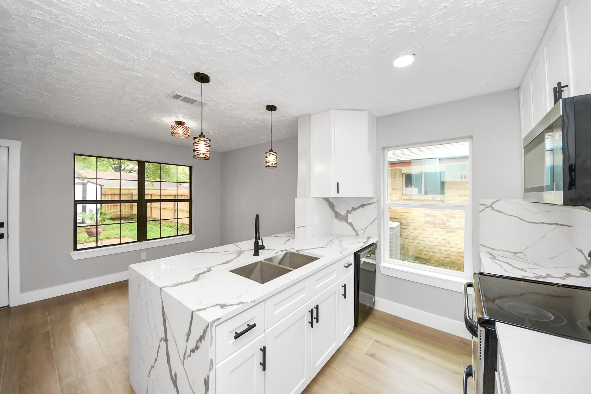20010 Cottonglade Lane Humble, TX 77338 - Photo 6 of 27 a kitchen with a sink stove and wooden floor