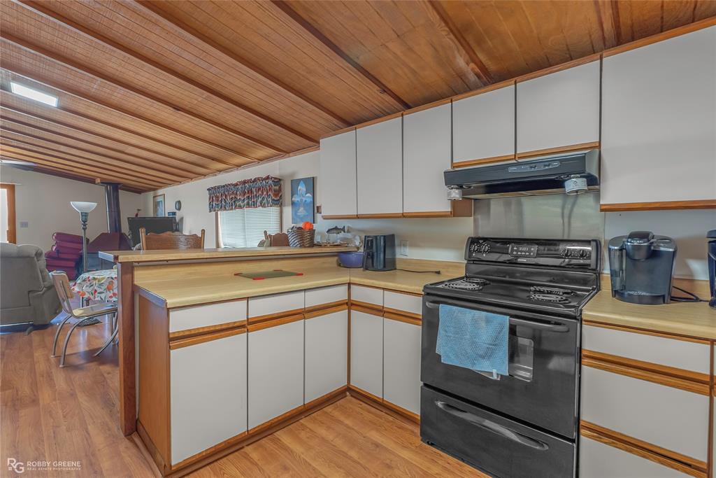 114 Quail Trail Homer, LA 71040 - Photo 20 of 40 a kitchen with a stove and wooden cabinets