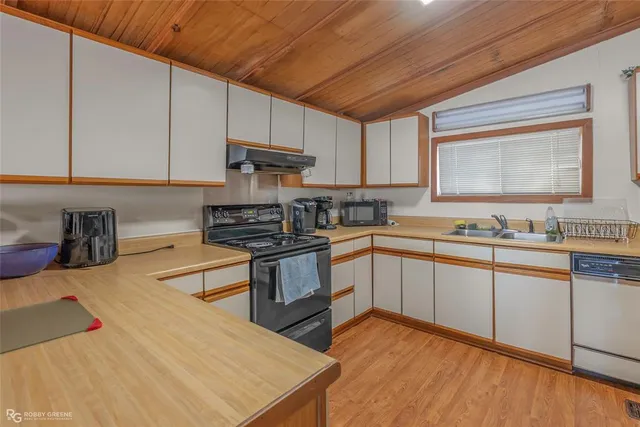 a kitchen with stainless steel appliances kitchen island granite countertop a refrigerator and a stove