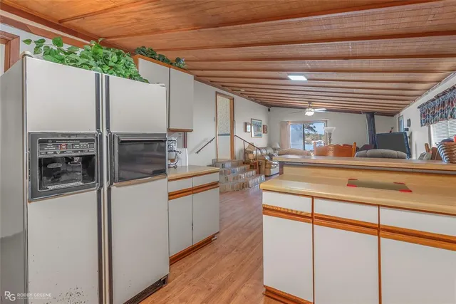 a kitchen with a stove and wooden cabinets
