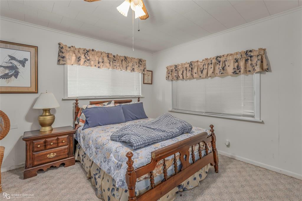 114 Quail Trail Homer, LA 71040 - Photo 23 of 40 a bedroom with a bed and a chandelier