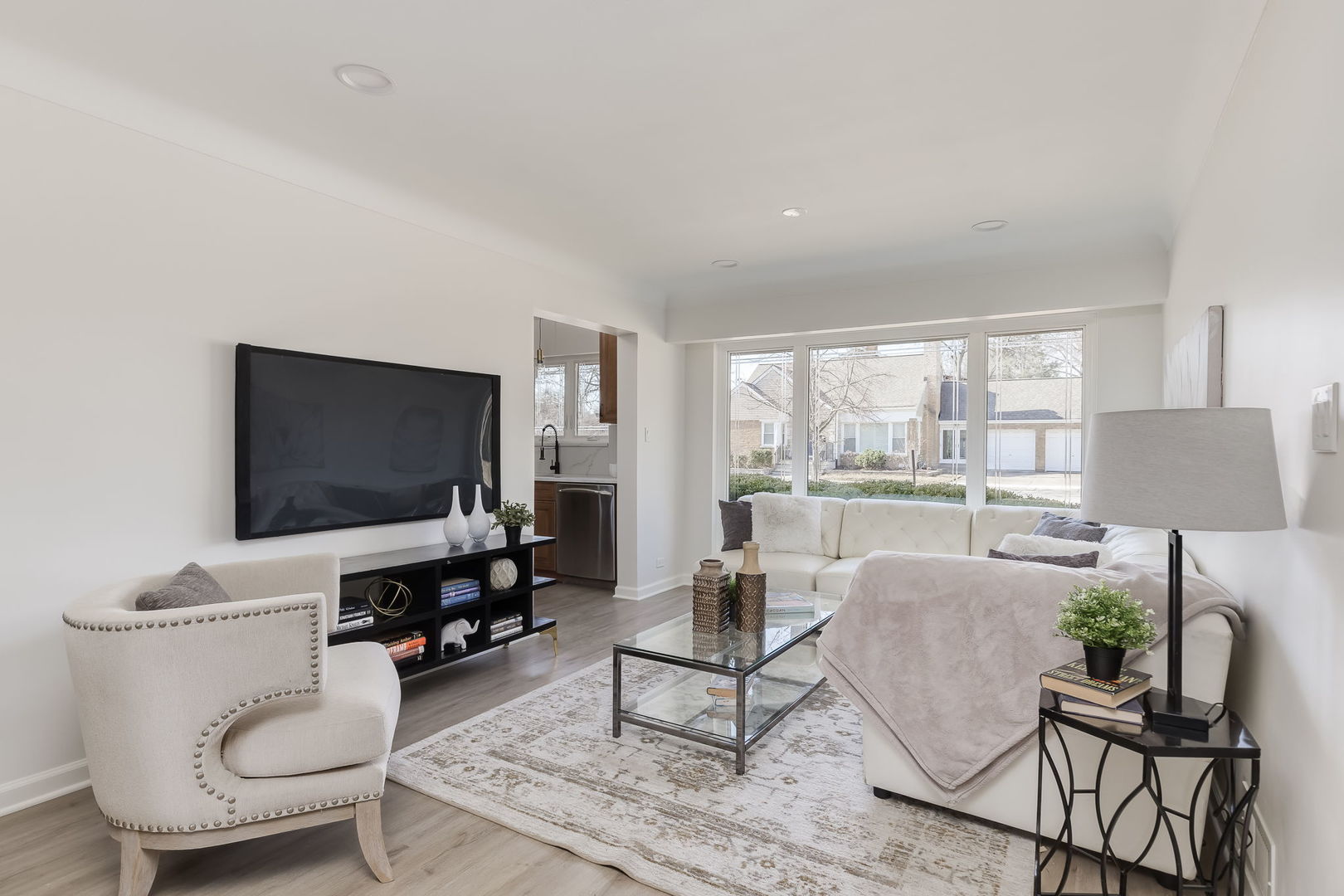 501 Byrd Road Riverside, IL 60546 - Photo 11 of 29 a living room with furniture a flat screen tv and a large window