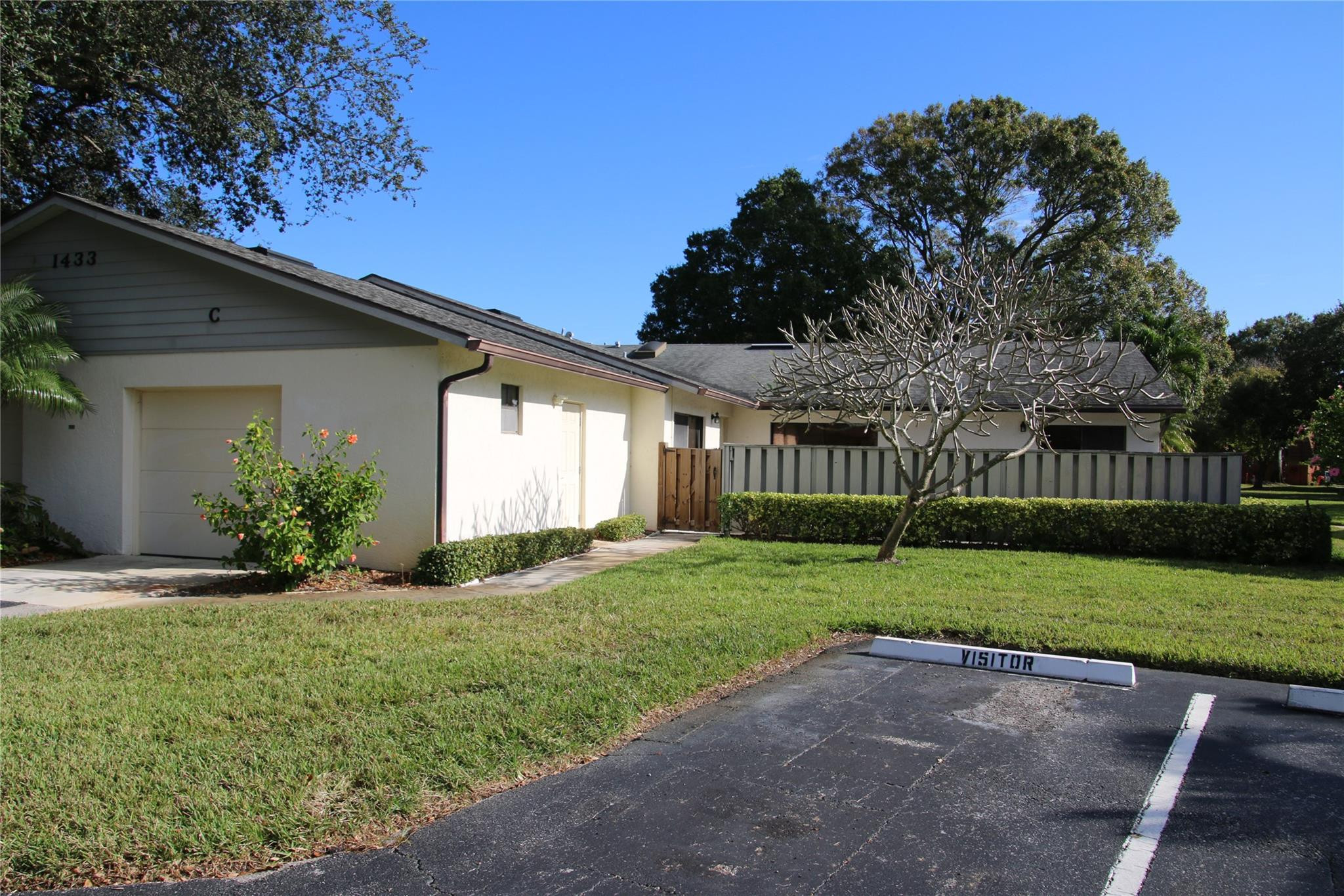 1433 Captains Walk, Unit C Fort Pierce, FL 34950 - Photo 11 of 11 a view of a house with a big yard plants and large trees
