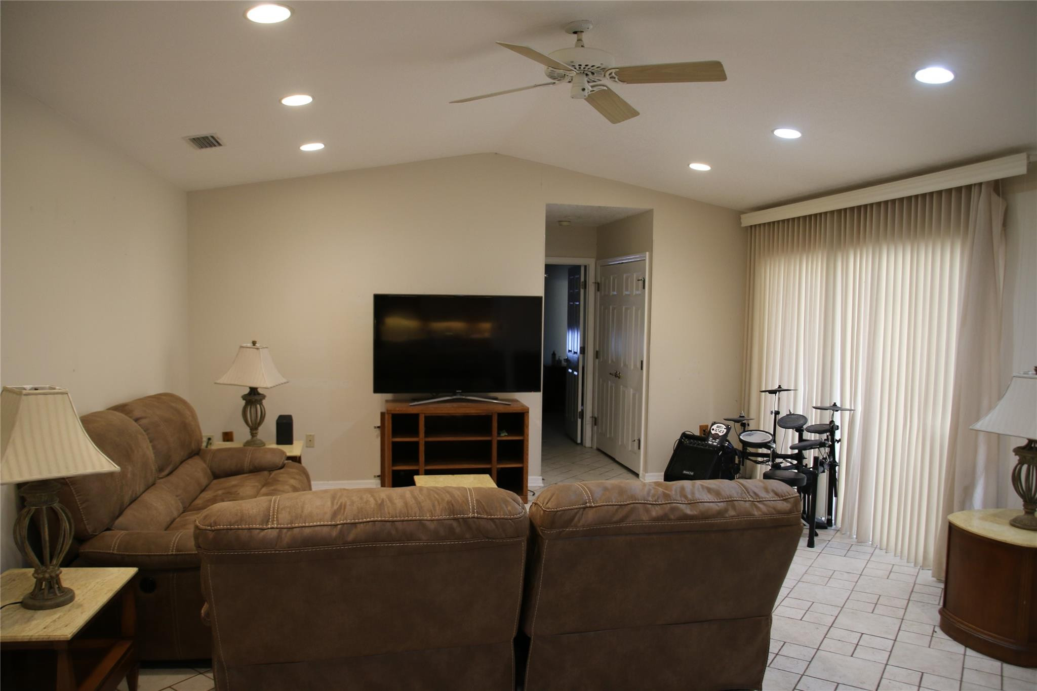 1433 Captains Walk, Unit C Fort Pierce, FL 34950 - Photo 3 of 11 a living room with furniture and a flat screen tv