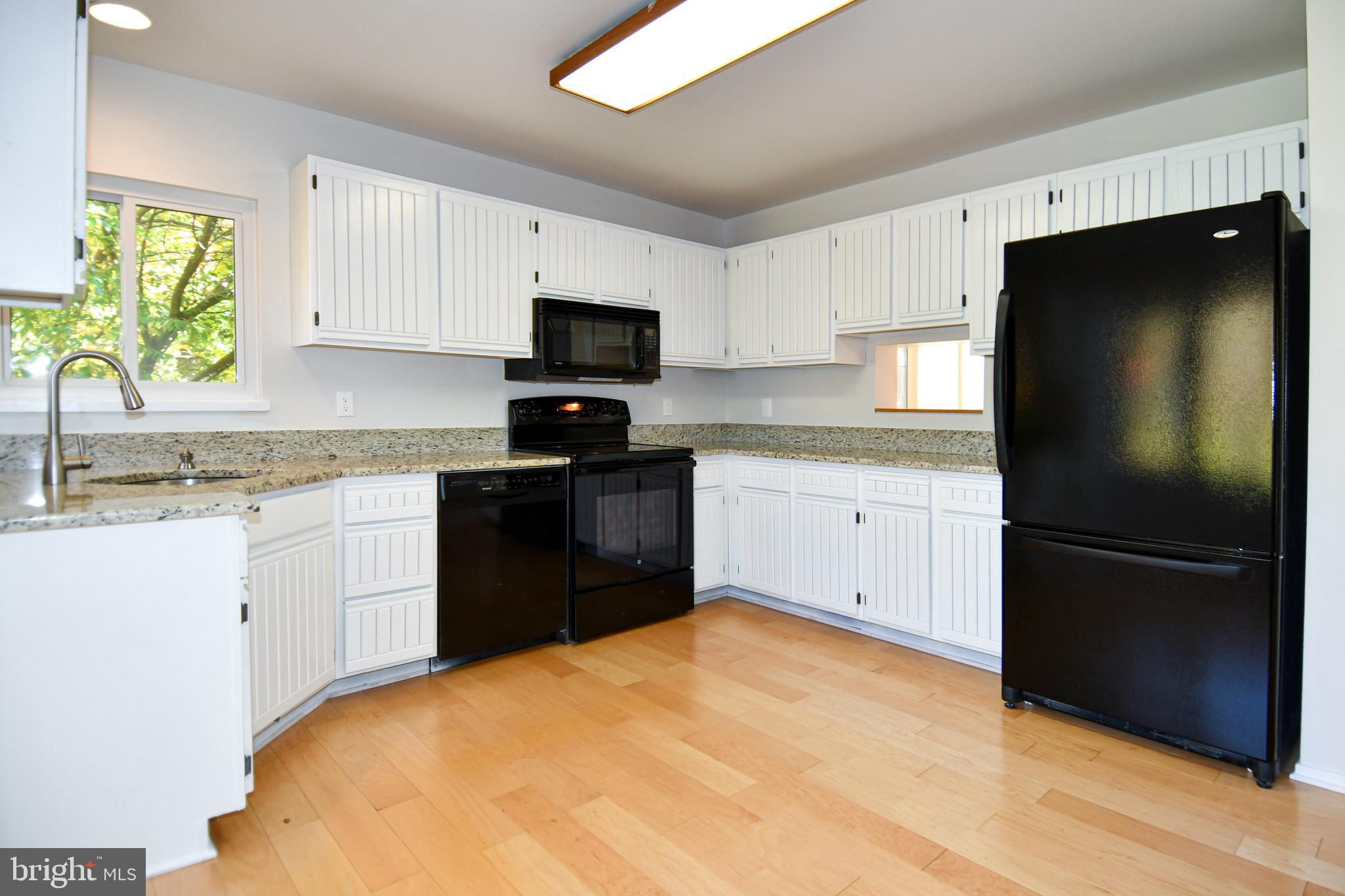 39 Windwhisper Lane Annapolis, MD 21403 - Photo 17 of 64 a kitchen with a refrigerator sink and microwave