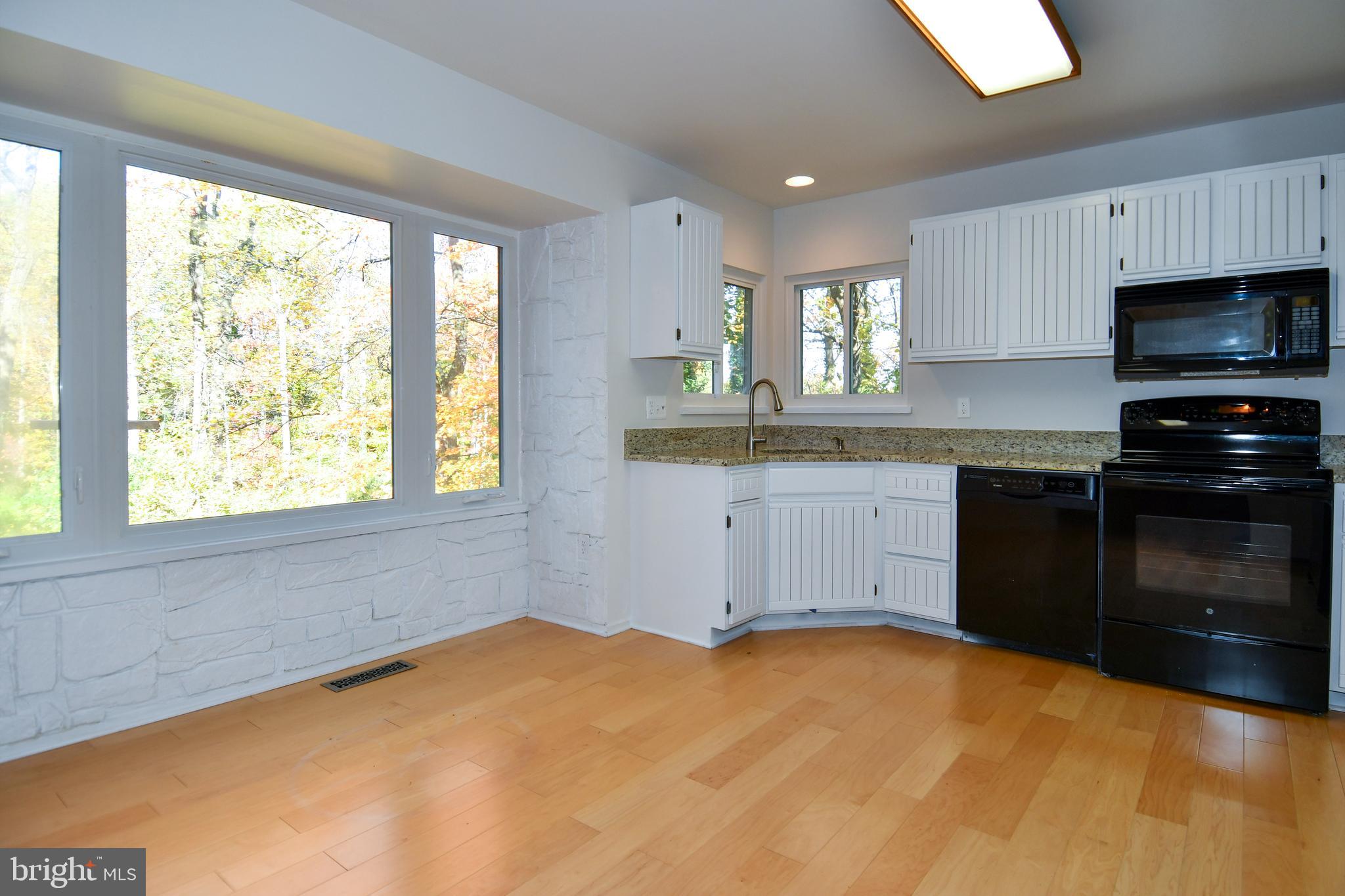 39 Windwhisper Lane Annapolis, MD 21403 - Photo 19 of 64 a kitchen with a stove a sink and a window
