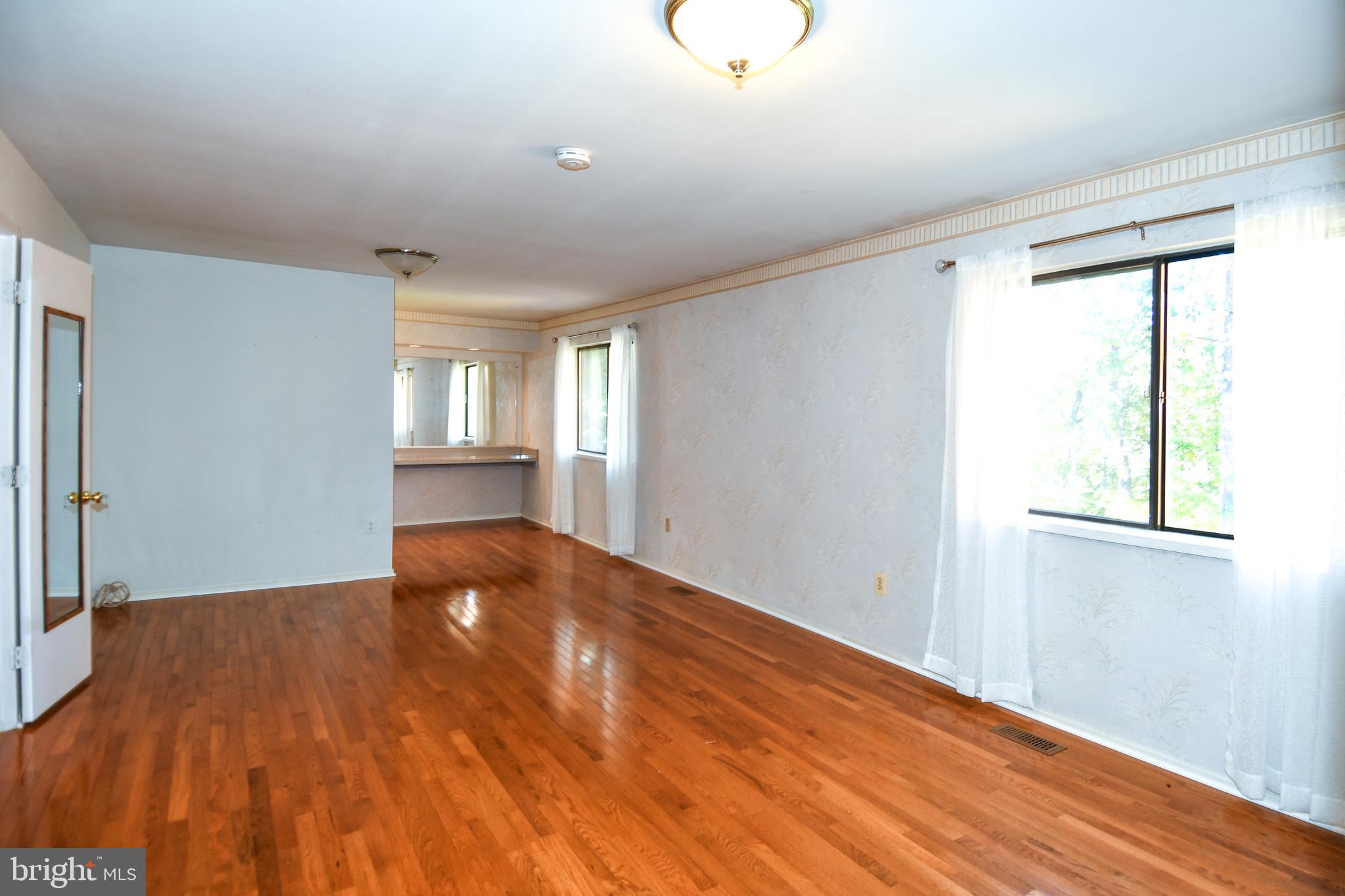 39 Windwhisper Lane Annapolis, MD 21403 - Photo 35 of 64 a view of an empty room with wooden floor and a window