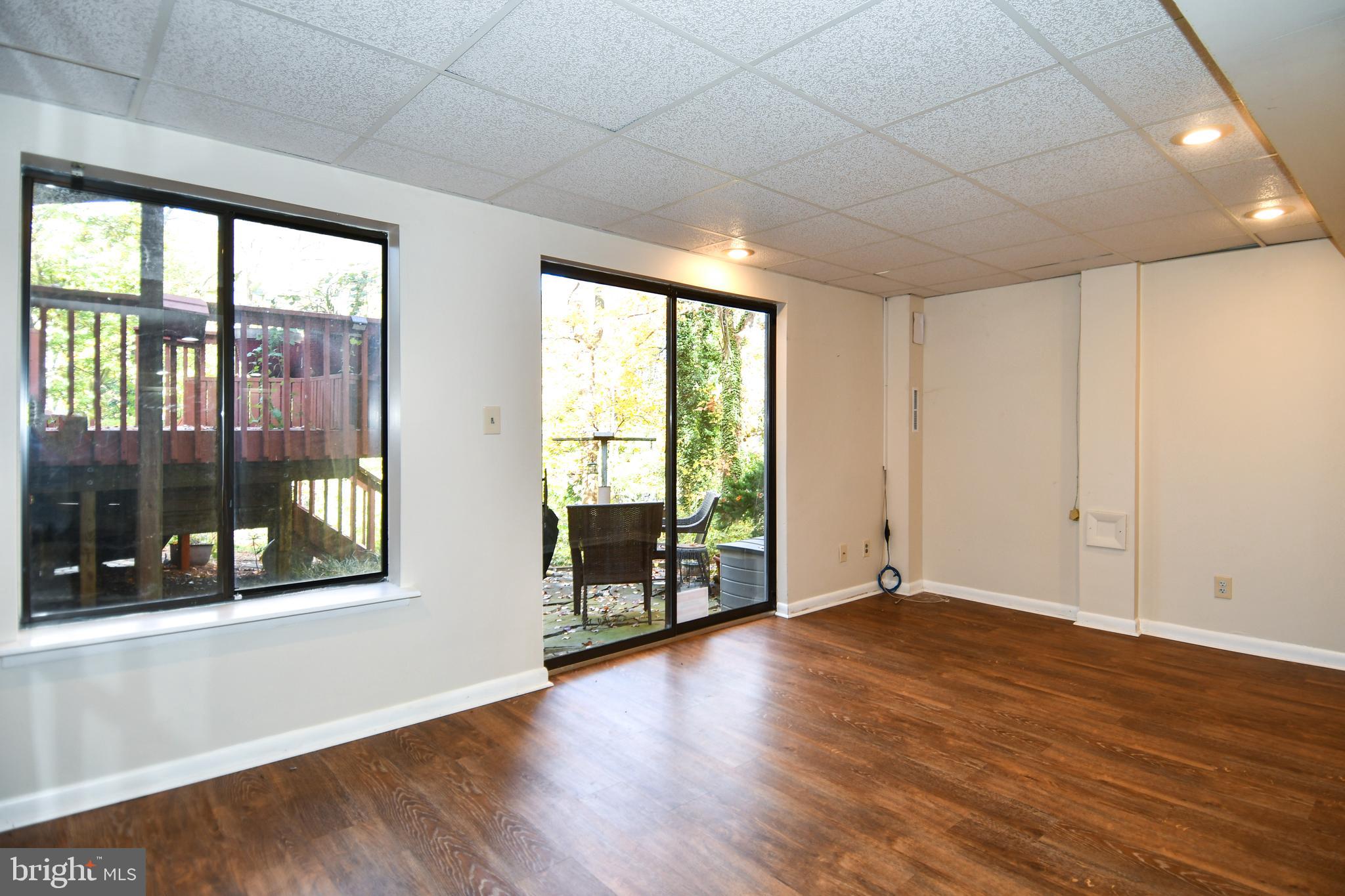 39 Windwhisper Lane Annapolis, MD 21403 - Photo 36 of 64 a view of an empty room with wooden floor and a window