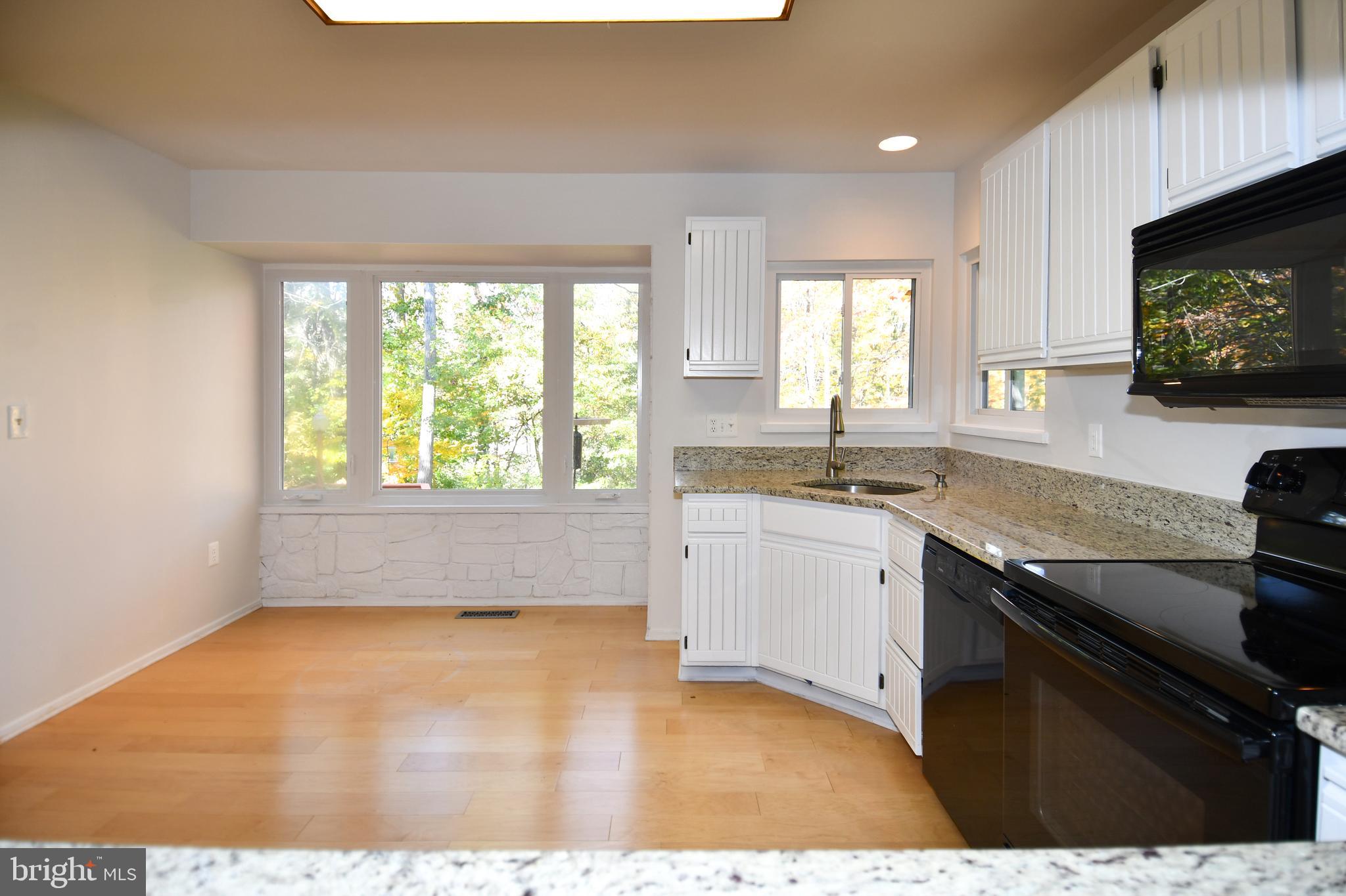 39 Windwhisper Lane Annapolis, MD 21403 - Photo 52 of 64 a kitchen with granite countertop a sink stainless steel appliances and a window