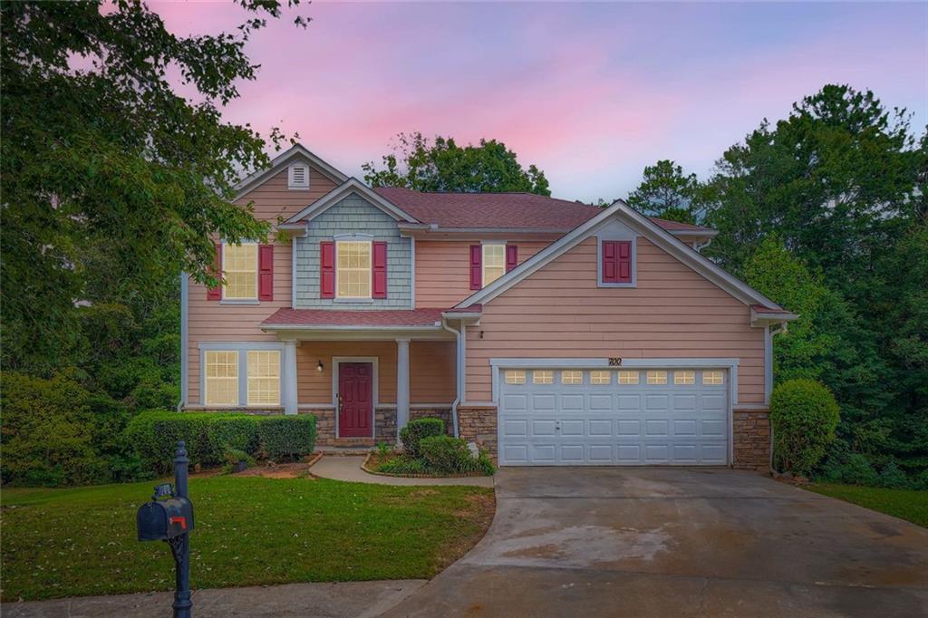 a front view of a house with a yard and garage