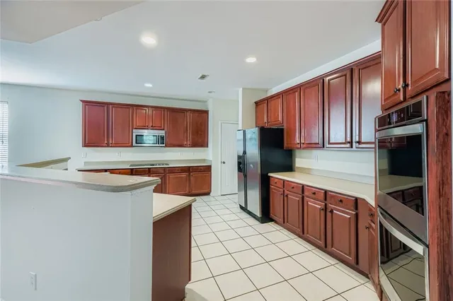 a kitchen with stainless steel appliances a sink and a stove