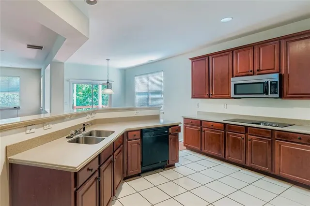 a kitchen with a sink stove top oven and microwave