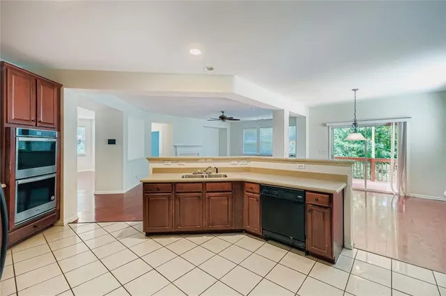 a kitchen with stainless steel appliances granite countertop a stove and a sink