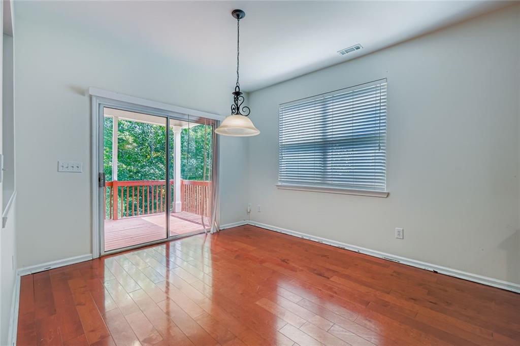 700 Kirkly Way Fairburn, GA 30213 - Photo 14 of 31 a view of an empty room with wooden floor and a window