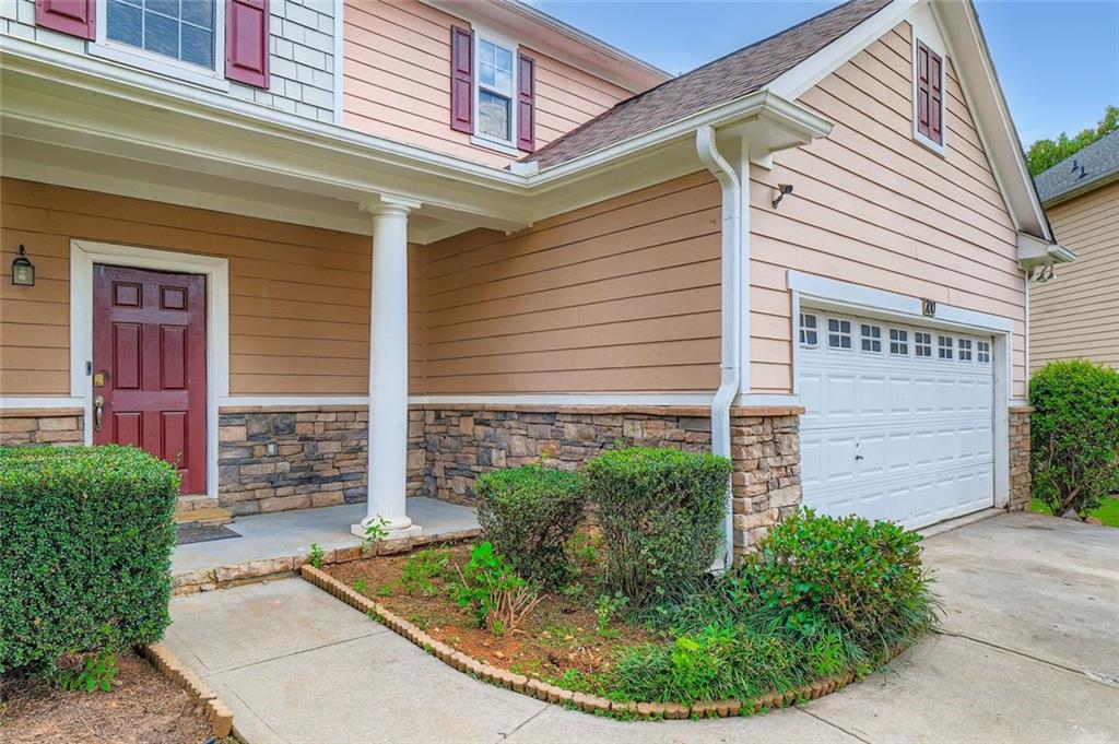 700 Kirkly Way Fairburn, GA 30213 - Photo 2 of 31 a view of brick house with potted plants
