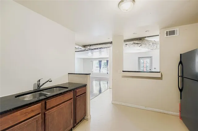 a kitchen with a refrigerator and a sink