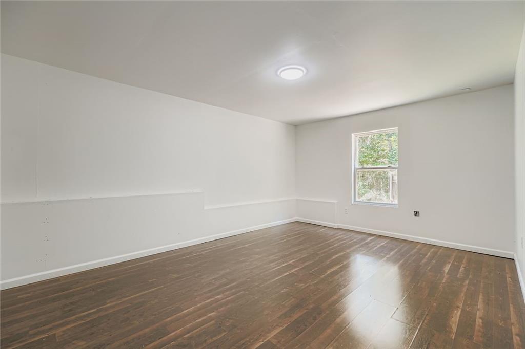 700 Kirkly Way Fairburn, GA 30213 - Photo 24 of 31 an empty room with wooden floor and windows
