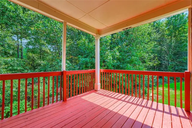 a balcony with wooden floor and outdoor space