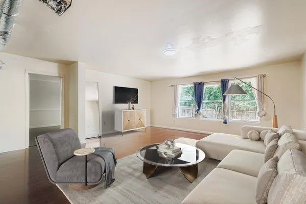 a living room with furniture and a large window