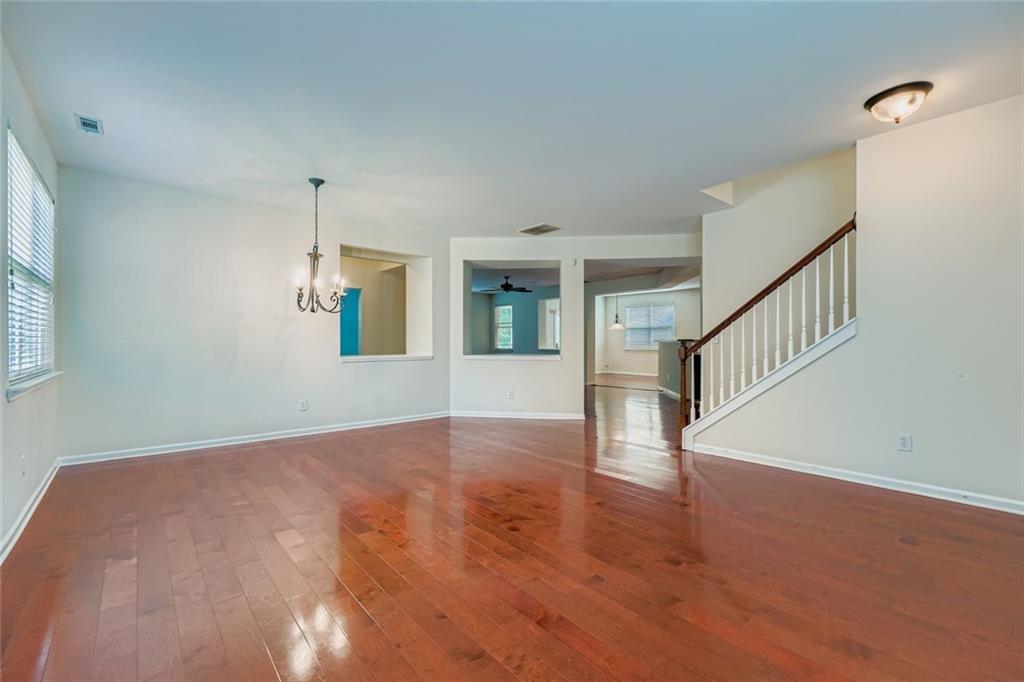 700 Kirkly Way Fairburn, GA 30213 - Photo 10 of 31 a view of an empty room with wooden floor and staircase