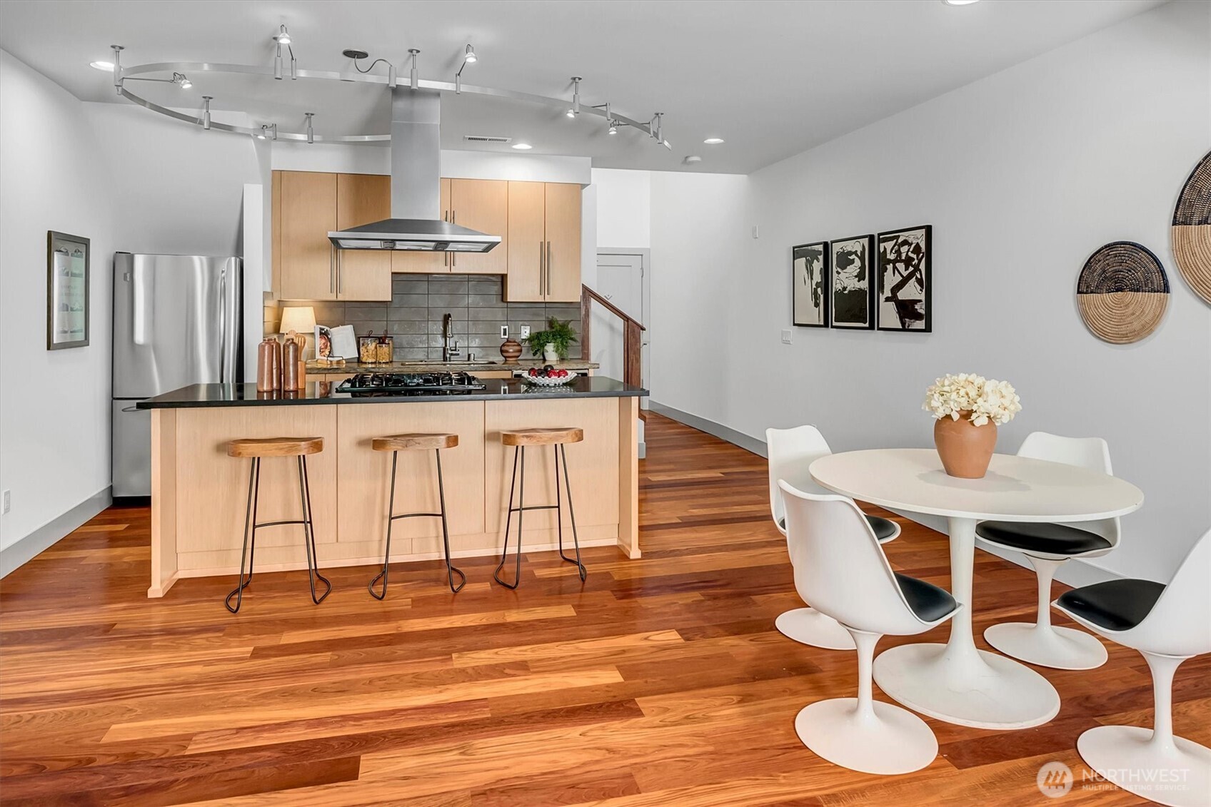 121 South Jackson Street, Unit 4 Seattle, WA 98104 - Photo 7 of 38 a kitchen with stainless steel appliances kitchen island a stove a table and chairs in it