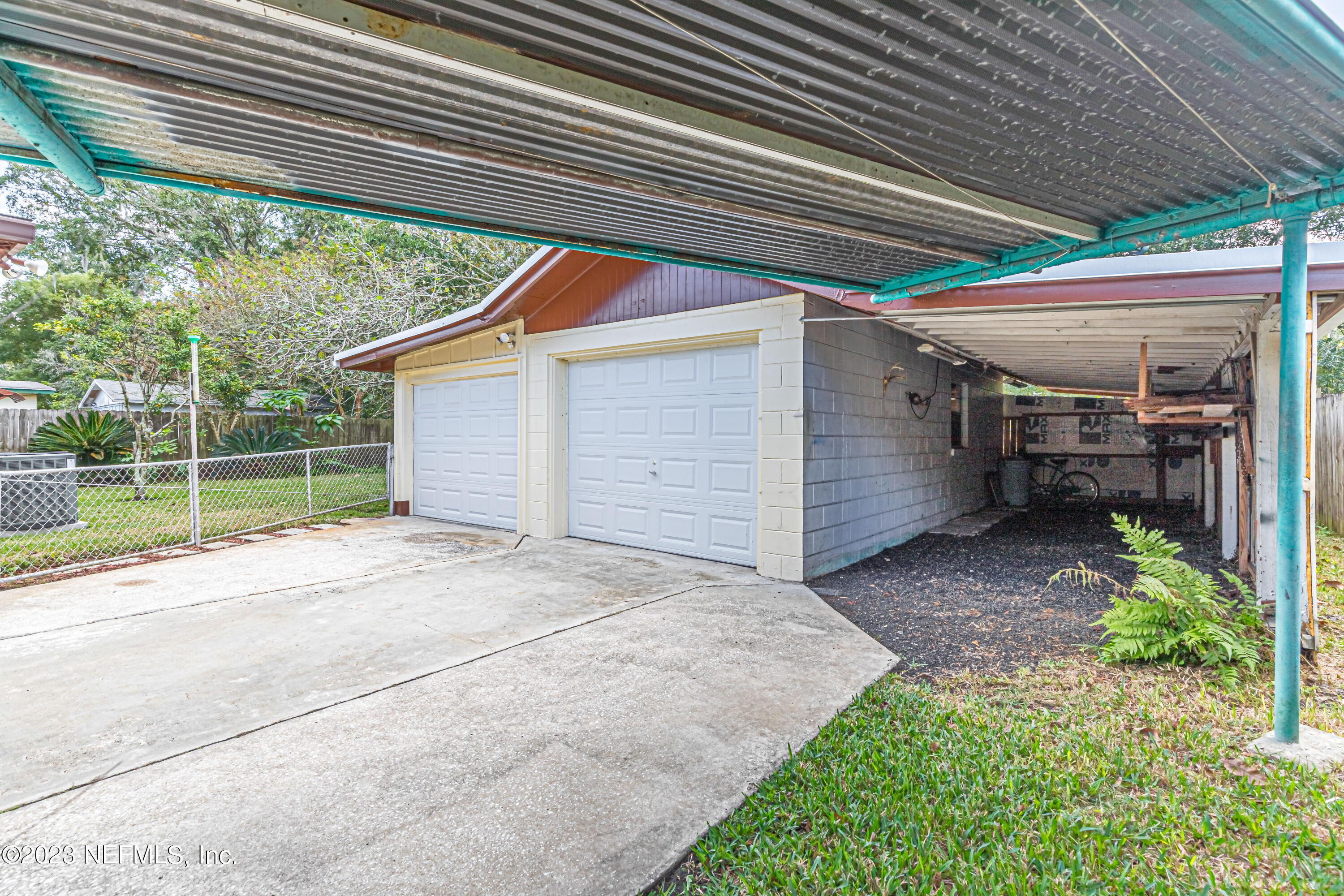 6956 Arques Road Jacksonville, FL 32205 - Photo 32 of 41 a view of a house with a backyard and floor to ceiling window