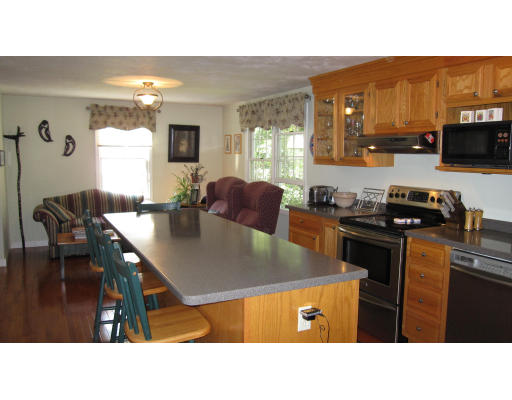 61 Clark Road Sturbridge, MA 01518 - Photo 5 of 17 a kitchen with stainless steel appliances kitchen island granite countertop a sink and cabinets