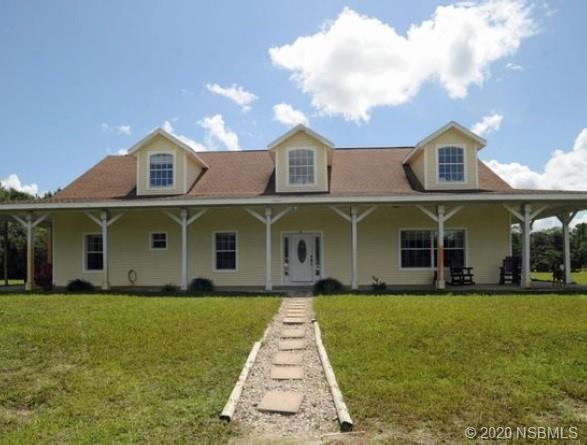 415 Stacy Grove Road Oak Hill, FL 32759 - Photo 1 of 25 a front view of a house with garden