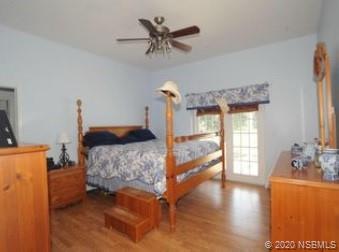 415 Stacy Grove Road Oak Hill, FL 32759 - Photo 14 of 25 a bedroom with furniture and a wooden floor