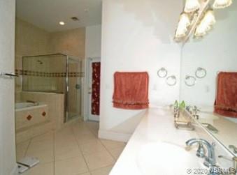 415 Stacy Grove Road Oak Hill, FL 32759 - Photo 15 of 25 a bathroom with a tub shower and a sink