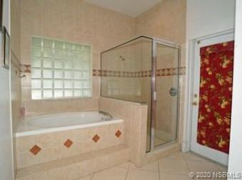 415 Stacy Grove Road Oak Hill, FL 32759 - Photo 16 of 25 a bathroom with a bathtub and a shower