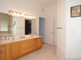 415 Stacy Grove Road Oak Hill, FL 32759 - Photo 17 of 25 a bathroom with a sink and a mirror