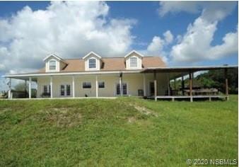 415 Stacy Grove Road Oak Hill, FL 32759 - Photo 3 of 25 a front view of a house with a garden